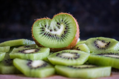 A selection of kiwi fruits, with one shaped like a heart