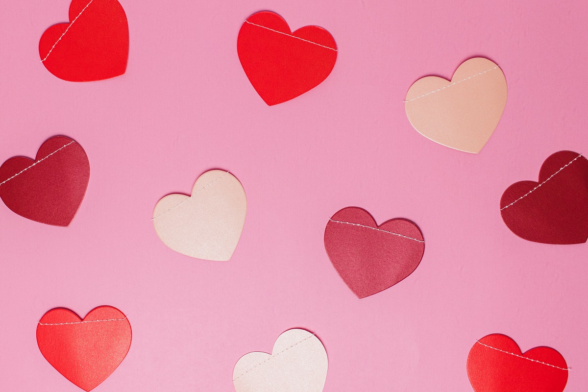 A flatlay of pink, red and white paper hearts for Valentine's Day