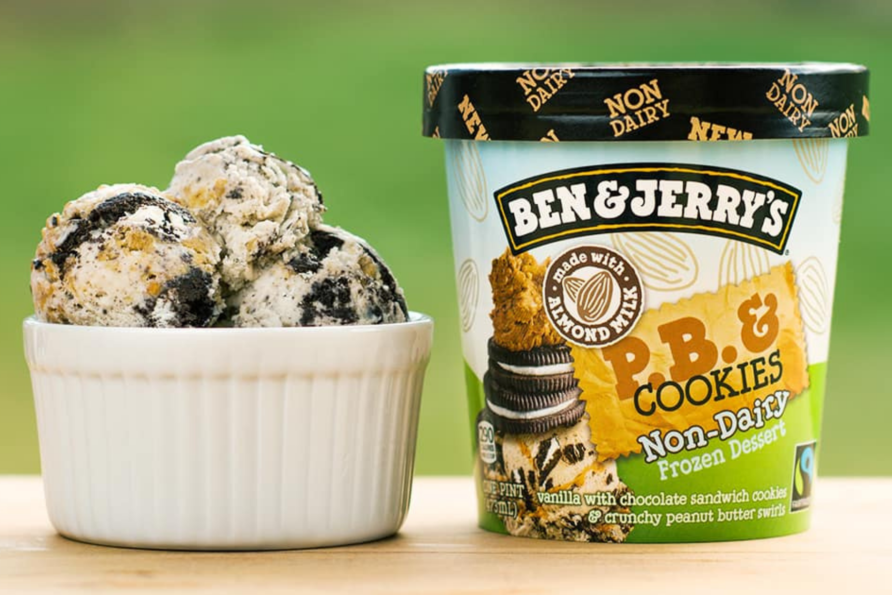 Scoops of ice cream in a bowl next to a pint of Ben & Jerry's Peanut Butter & Cookies Non-Dairy ice cream