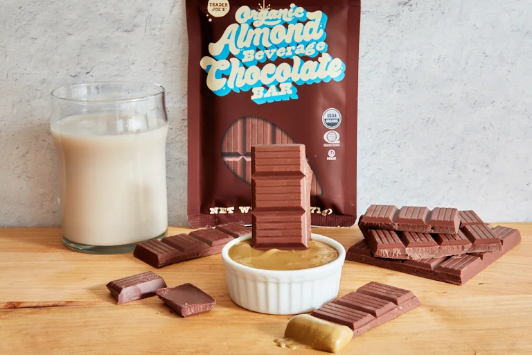 Trader Joe's Almond chocolate bars next to a glass of almond milk